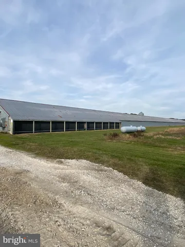 a view of house with outdoor space and parking