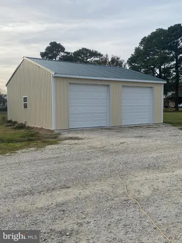 a view of a room with wooden floor and windows