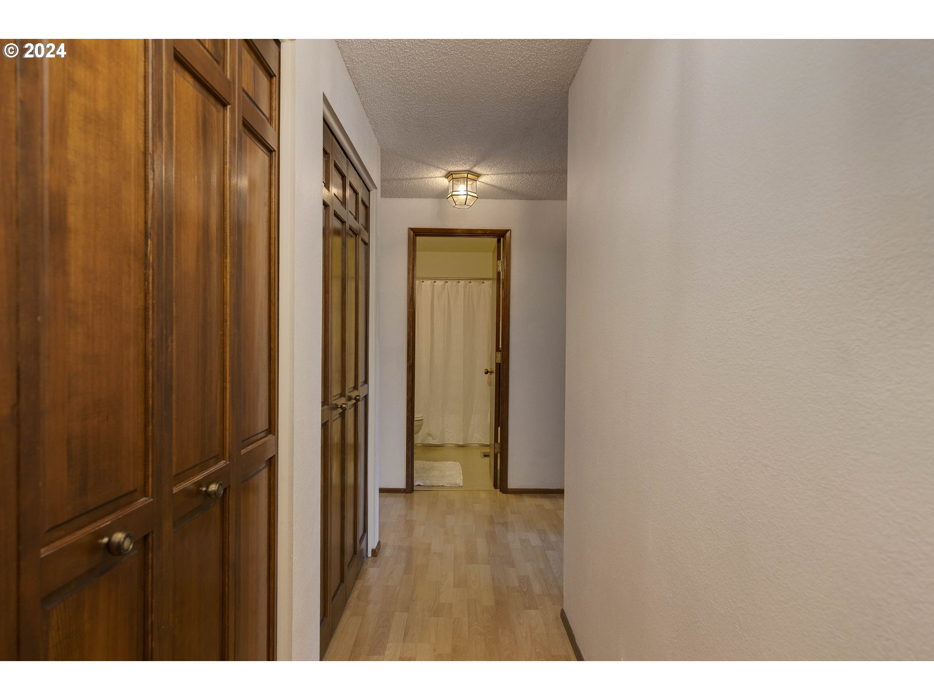 2466 Erin Way Eugene, OR 97408 - Photo 17 of 31 a view of a hallway with wooden floor