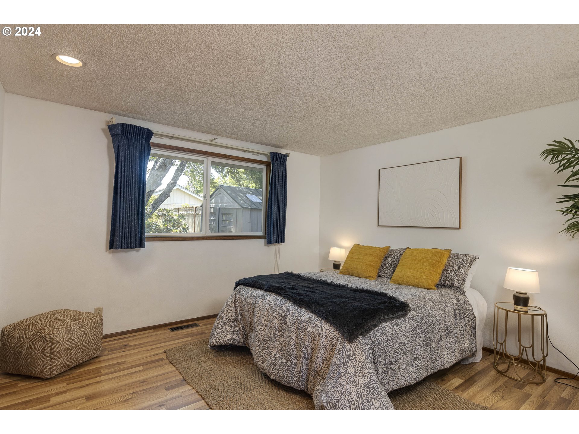 2466 Erin Way Eugene, OR 97408 - Photo 19 of 31 a bedroom with a bed and a painting on the wall