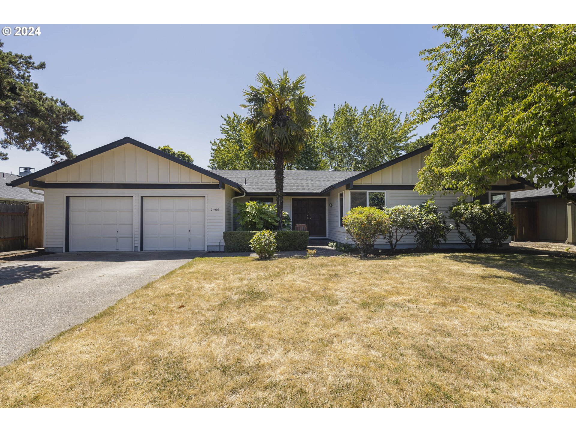 2466 Erin Way Eugene, OR 97408 - Photo 2 of 31 a front view of a house with a yard and garage