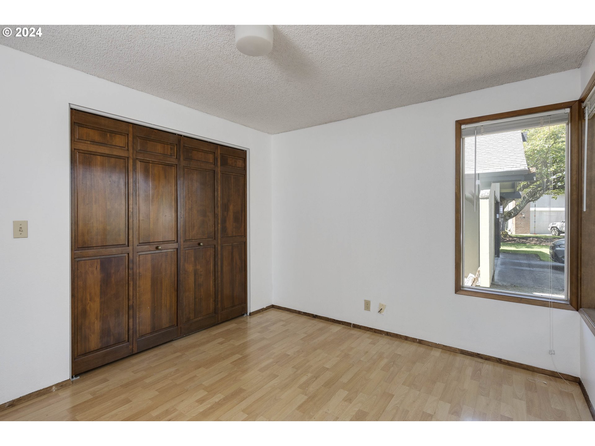 2466 Erin Way Eugene, OR 97408 - Photo 25 of 31 a view of an empty room with wooden floor and a window