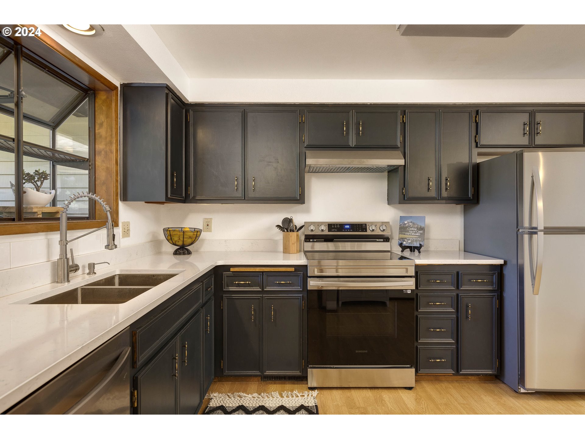 2466 Erin Way Eugene, OR 97408 - Photo 8 of 31 a kitchen with a sink and a refrigerator
