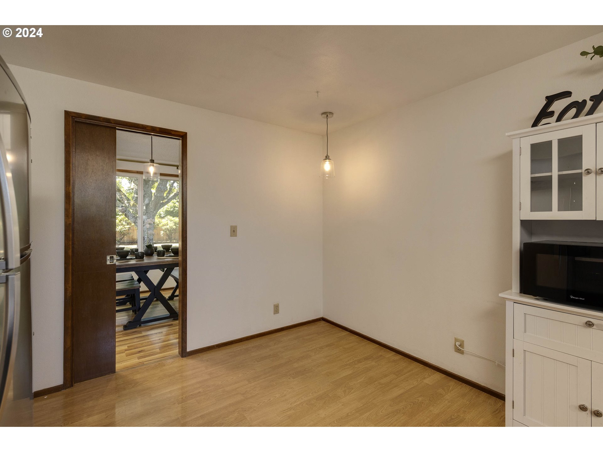 2466 Erin Way Eugene, OR 97408 - Photo 10 of 31 a view of empty room with windows and cabinet