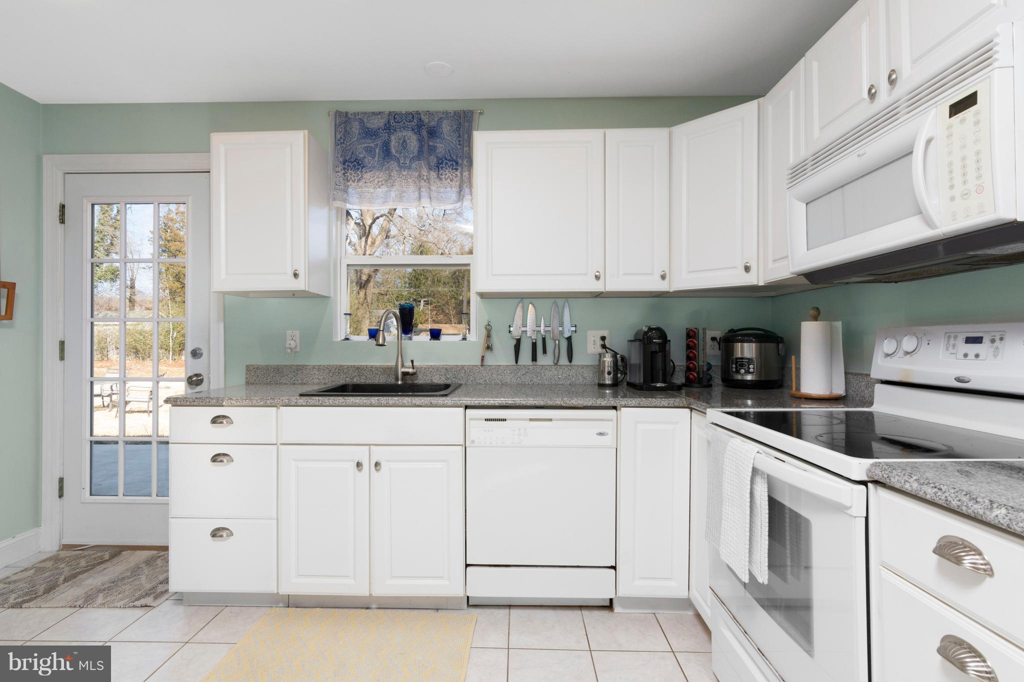 3749 Ridgewood Road Davidsonville, MD 21035 - Photo 10 of 28 Bright white kitchen with door to patio