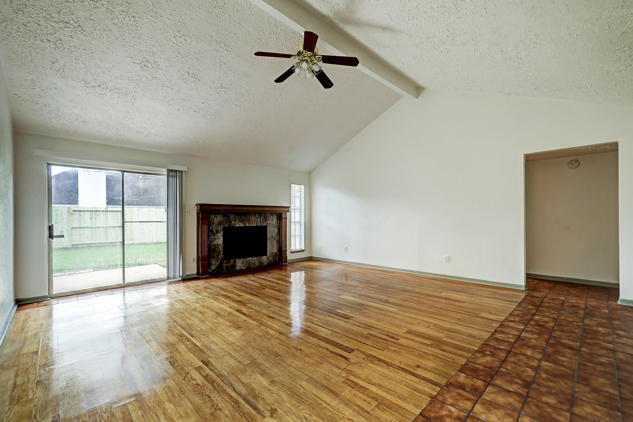 1906 Iron Ridge Sugar Land, TX 77478 - Photo 6 of 12 an empty room with chandelier fan and windows