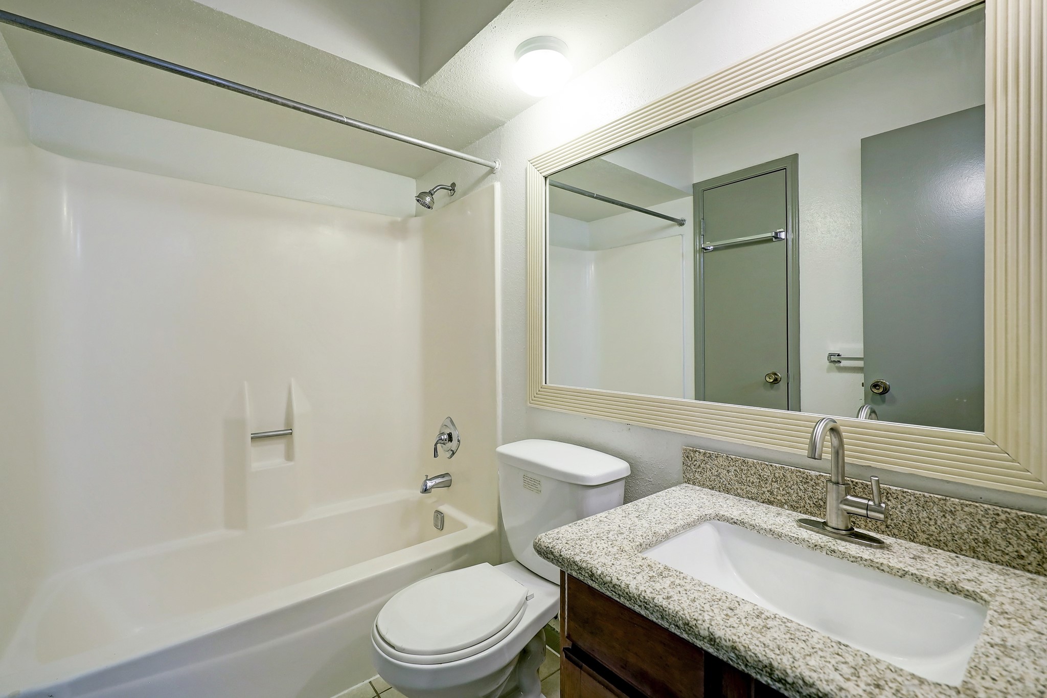 1906 Iron Ridge Sugar Land, TX 77478 - Photo 10 of 12 a bathroom with a granite countertop sink toilet tub and shower