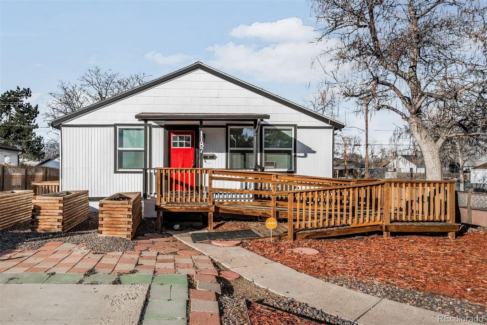 1187 Syracuse Street Denver, CO 80220 - Photo 1 of 34 a front view of a house with a patio