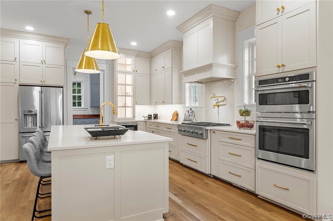 3611 Brook Road Richmond, VA 23227 - Photo 15 of 49 a kitchen with stainless steel appliances a stove a sink cabinets and a refrigerator