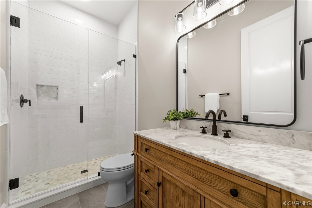 3611 Brook Road Richmond, VA 23227 - Photo 22 of 49 a bathroom with a granite countertop sink a toilet and shower