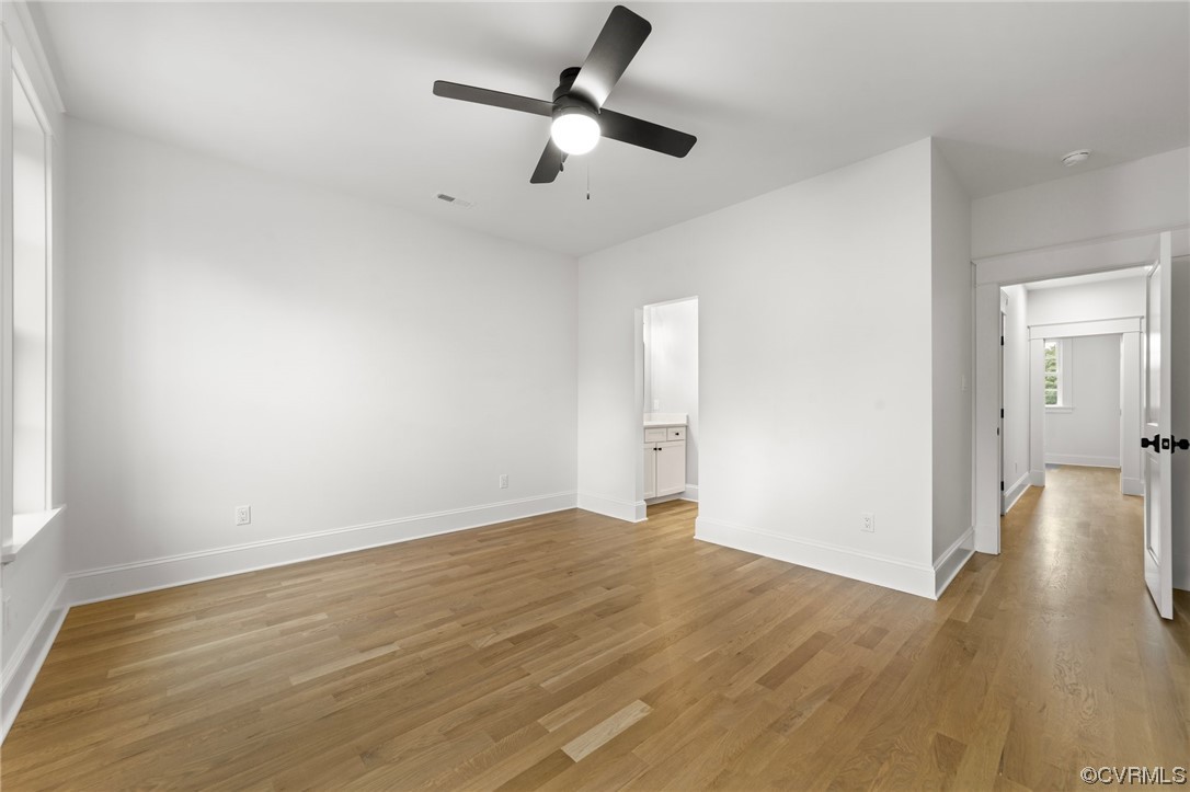 3611 Brook Road Richmond, VA 23227 - Photo 45 of 49 an empty room with wooden floor ceiling fan and windows