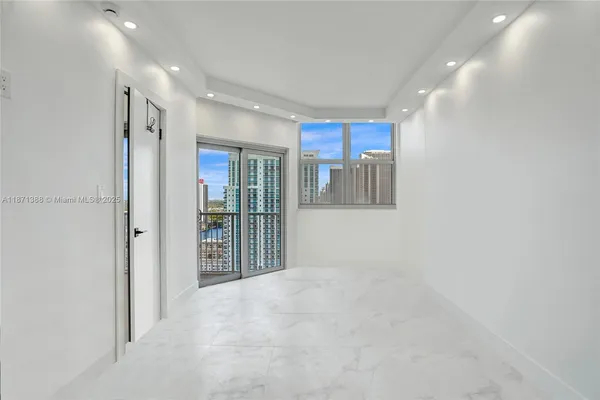 a view of hallway with a large window and stainless steel appliances