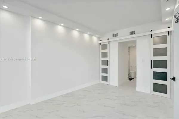a view of an empty room with a cabinet