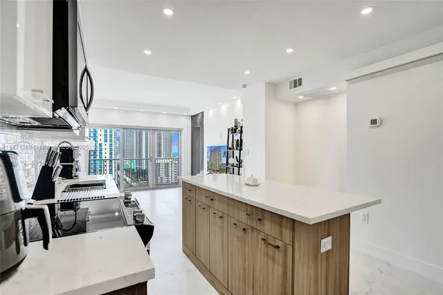 a kitchen with a sink a stove and a refrigerator