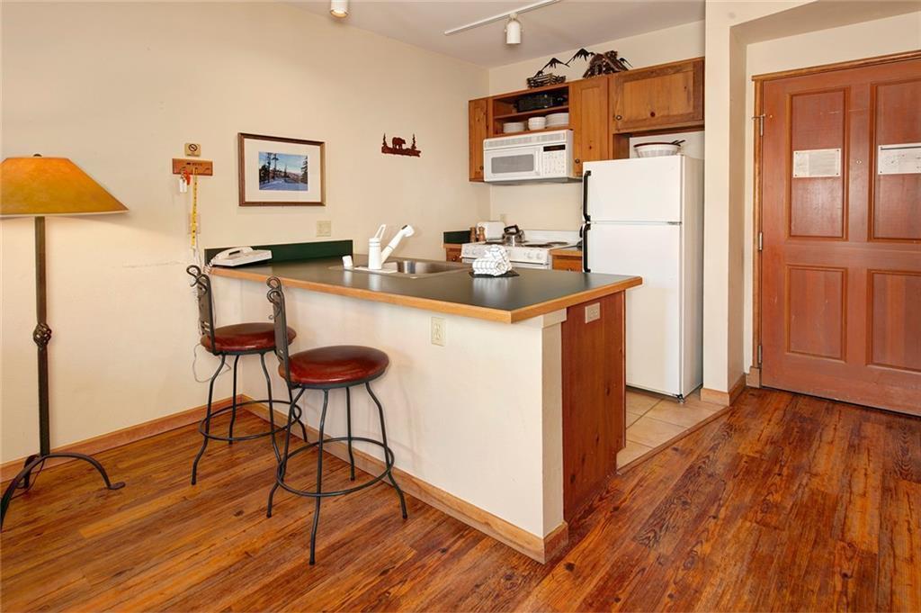 129 River Run Road, Unit 8058 Keystone, CO 80435 - Photo 12 of 35 a kitchen with stainless steel appliances granite countertop a refrigerator and a stove top oven