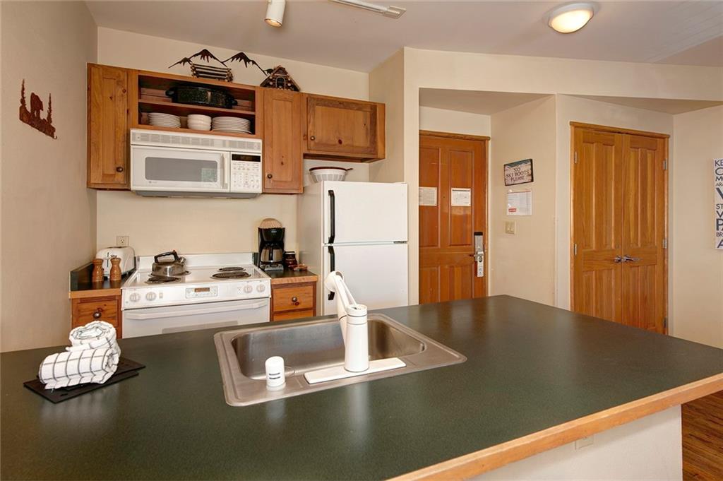 129 River Run Road, Unit 8058 Keystone, CO 80435 - Photo 15 of 35 a living room with kitchen island furniture and a kitchen view
