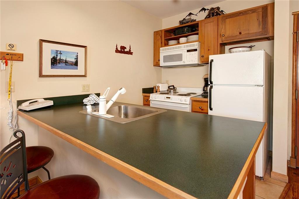 129 River Run Road, Unit 8058 Keystone, CO 80435 - Photo 16 of 35 a kitchen with a sink a stove and a refrigerator