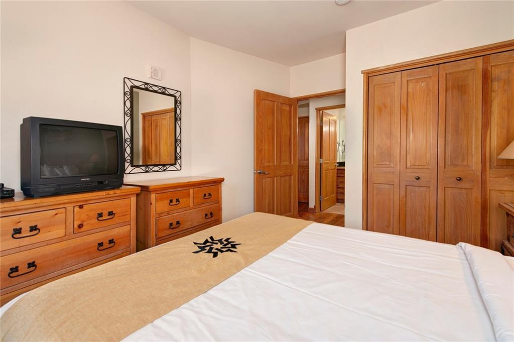 129 River Run Road, Unit 8058 Keystone, CO 80435 - Photo 18 of 35 a bedroom with a bed and a flat screen tv