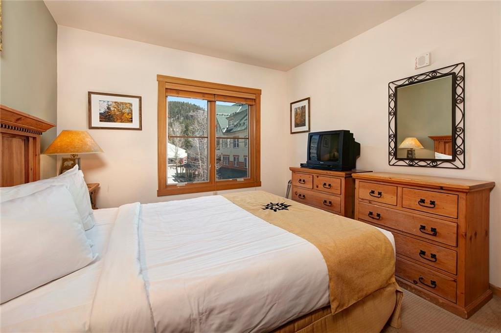 129 River Run Road, Unit 8058 Keystone, CO 80435 - Photo 20 of 35 a bedroom with a bed and wooden floor