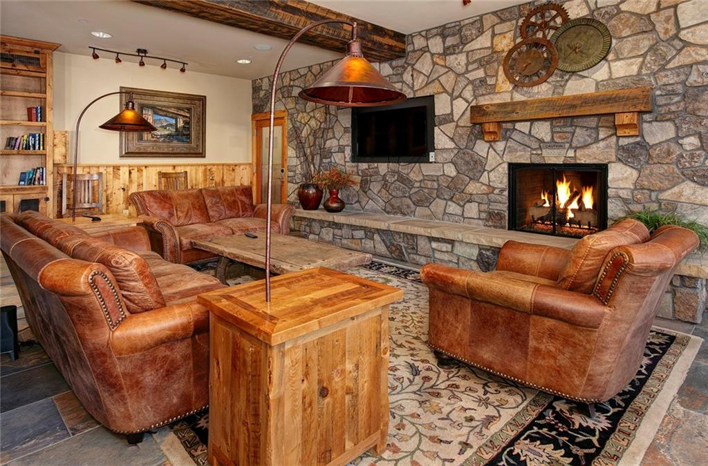 129 River Run Road, Unit 8058 Keystone, CO 80435 - Photo 22 of 35 a living room with furniture a flat screen tv and a fireplace