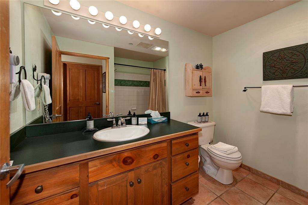 129 River Run Road, Unit 8058 Keystone, CO 80435 - Photo 23 of 35 a bathroom with a sink a toilet and a mirror