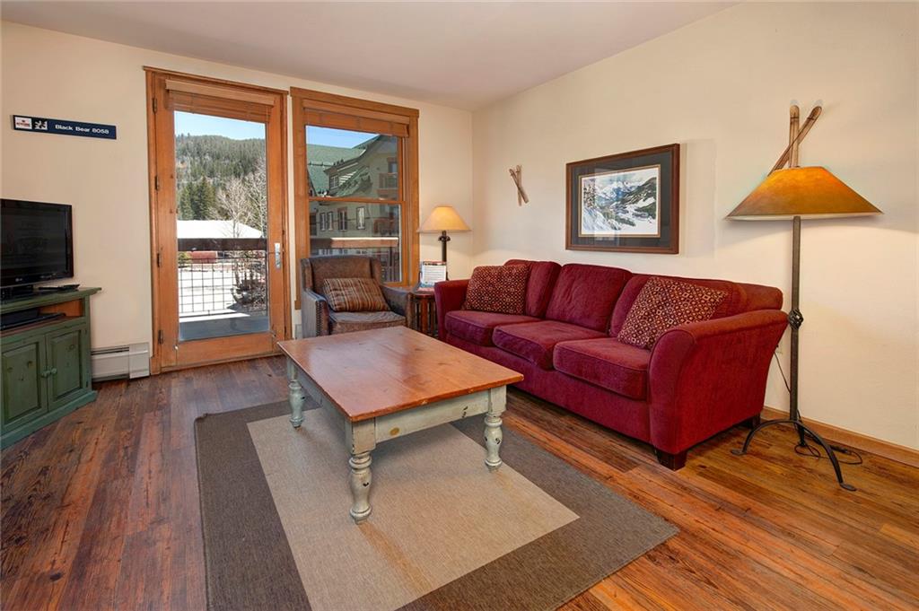 129 River Run Road, Unit 8058 Keystone, CO 80435 - Photo 8 of 35 a living room with furniture a flat screen tv and a large window