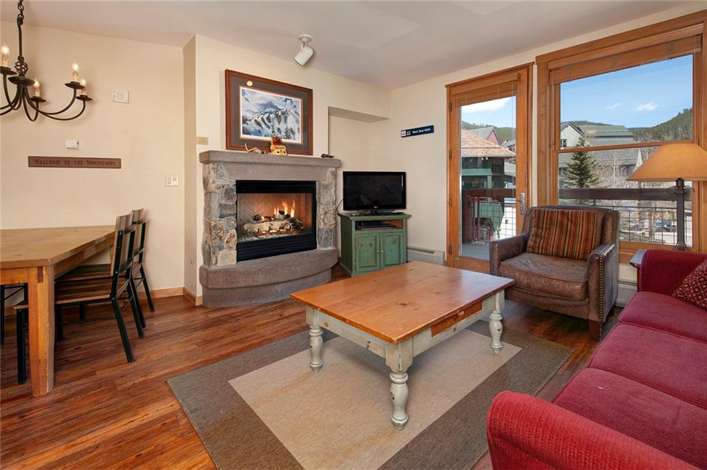 129 River Run Road, Unit 8058 Keystone, CO 80435 - Photo 9 of 35 a living room with furniture a flat screen tv and a fireplace