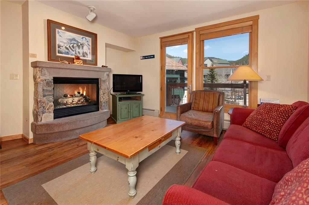 129 River Run Road, Unit 8058 Keystone, CO 80435 - Photo 10 of 35 a living room with furniture a flat screen tv and a fireplace