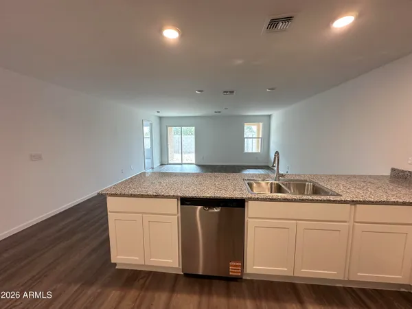a kitchen with a sink stove and cabinets