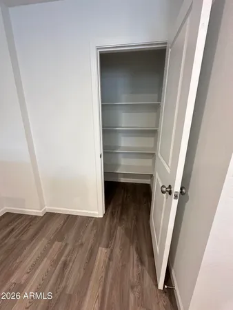 a view of walk in closet with empty racks