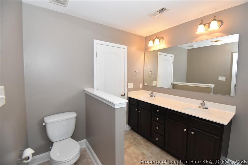 131 South Prince Henry Way Cameron, NC 28326 - Photo 7 of 26 a bathroom with a toilet sink and mirror