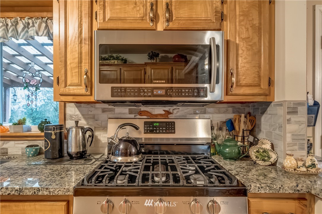 8883 North Pass Road Sumas, WA 98295 - Photo 17 of 25 a kitchen with granite countertop a stove and a sink