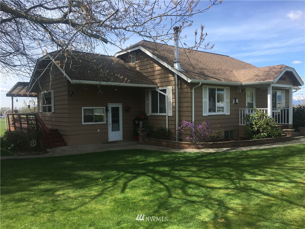 8883 North Pass Road Sumas, WA 98295 - Photo 3 of 25 a front view of a house with a yard