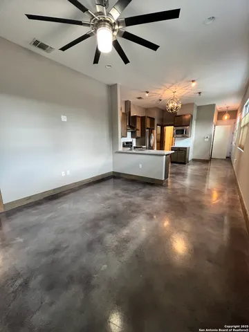 a view of a livingroom with furniture and a ceiling fan