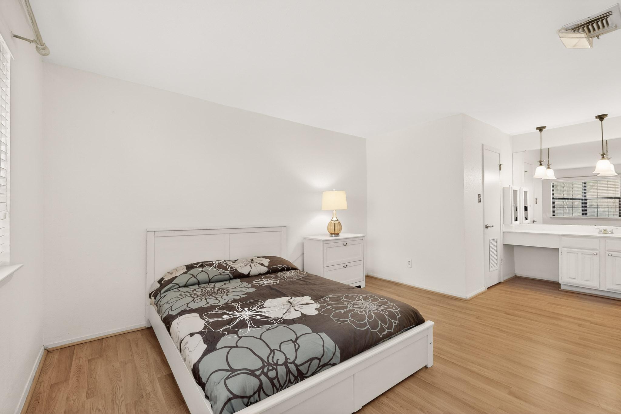 8210 Bent Tree Road, Unit 104 Austin, TX 78759 - Photo 14 of 39 Bedroom featuring light wood-type flooring and built in desk