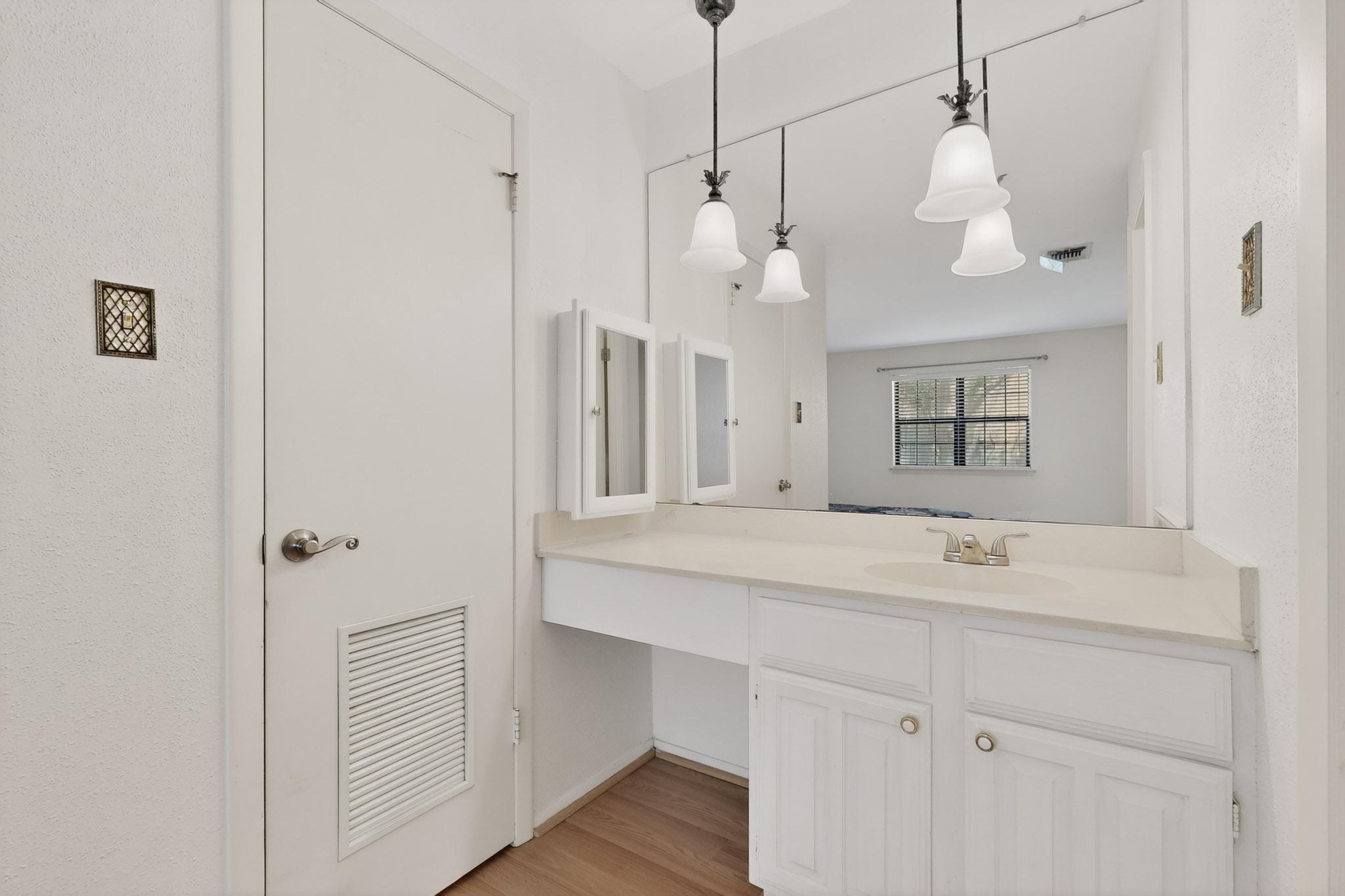 8210 Bent Tree Road, Unit 104 Austin, TX 78759 - Photo 17 of 39 Bathroom featuring vanity and light wood-type flooring