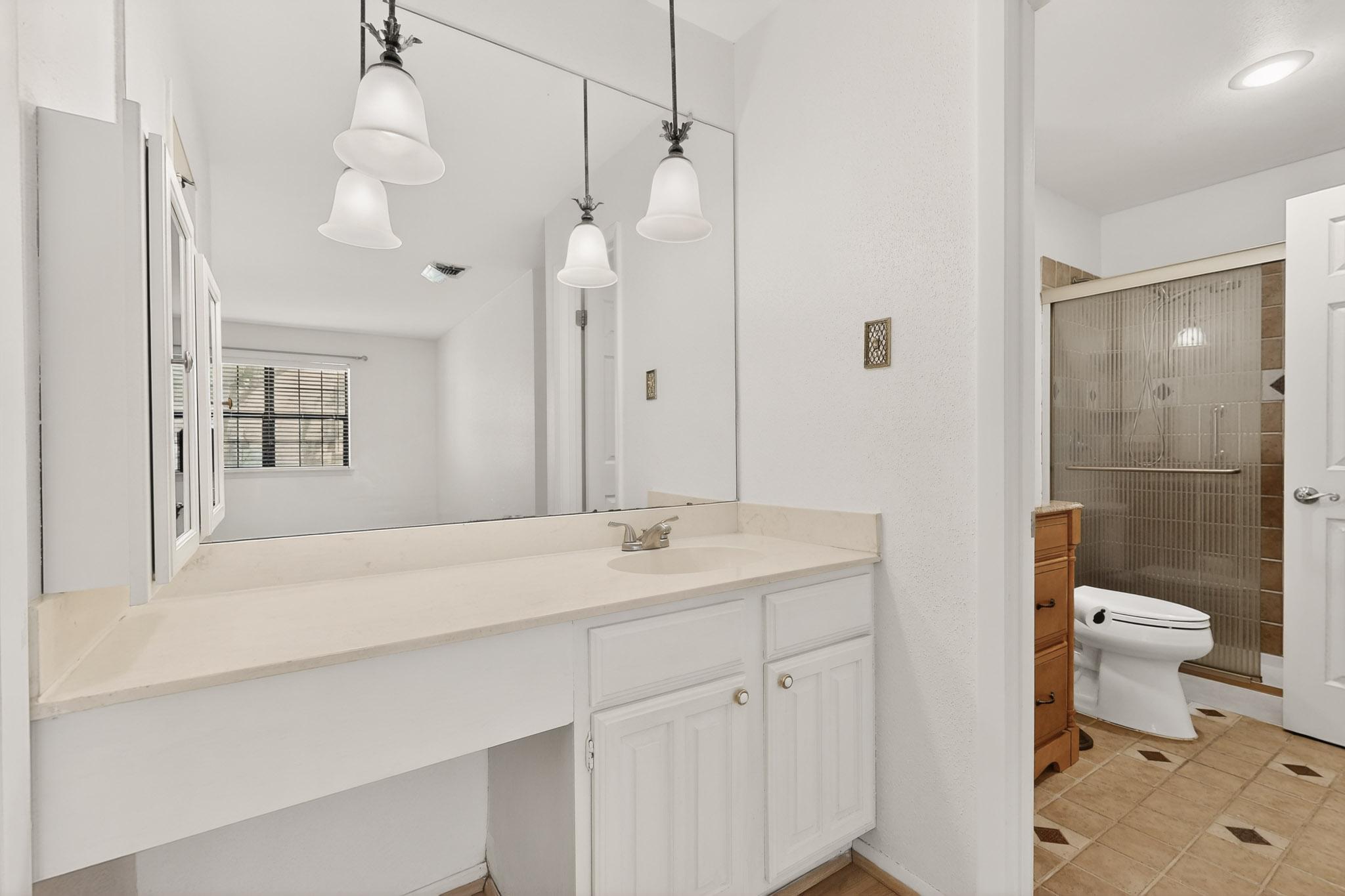 8210 Bent Tree Road, Unit 104 Austin, TX 78759 - Photo 18 of 39 Full bathroom with vanity, a shower stall, and light tile patterned flooring