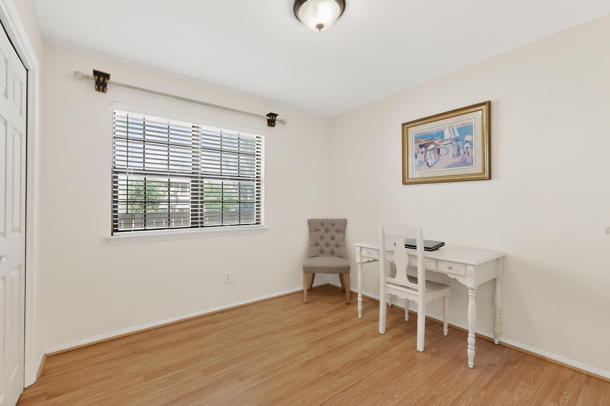 8210 Bent Tree Road, Unit 104 Austin, TX 78759 - Photo 21 of 39 Bedroom featuring light wood-style floors and baseboards