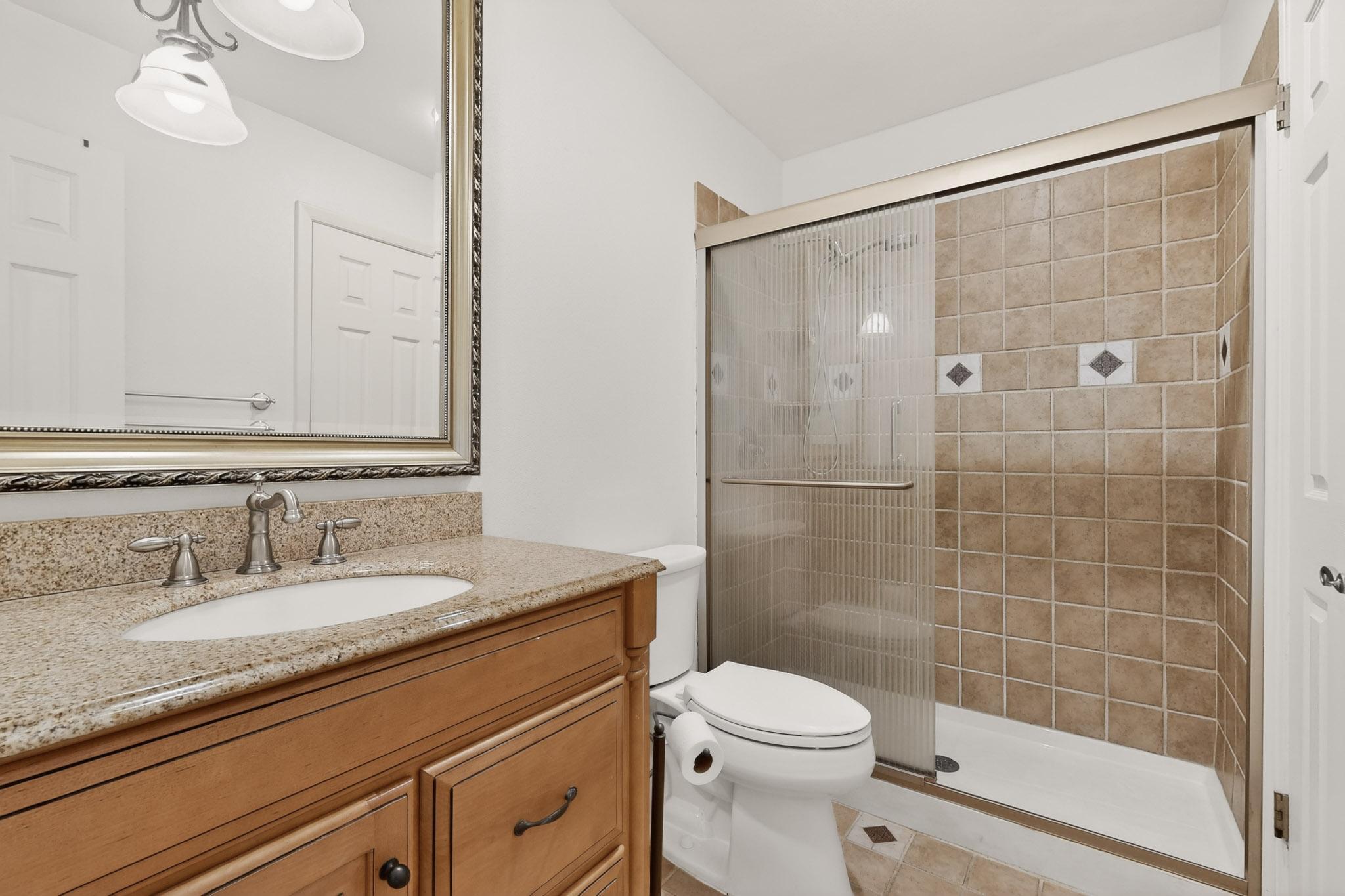8210 Bent Tree Road, Unit 104 Austin, TX 78759 - Photo 23 of 39 Full bathroom with vanity, a shower stall, and light tile patterned floors