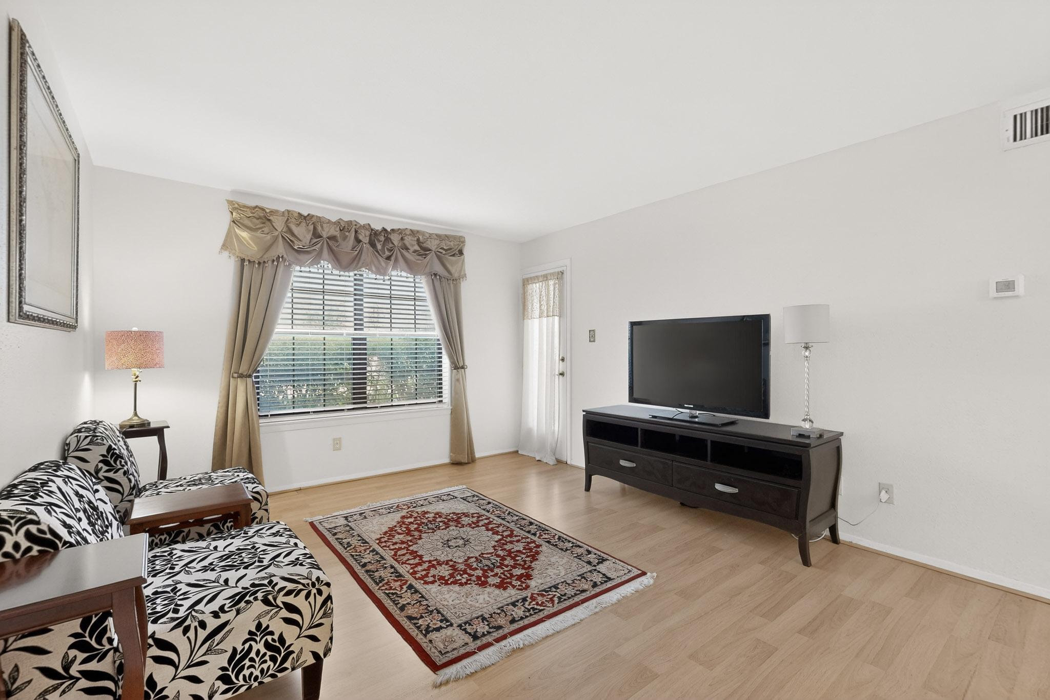 8210 Bent Tree Road, Unit 104 Austin, TX 78759 - Photo 6 of 39 Living area with light wood-style flooring and baseboards
