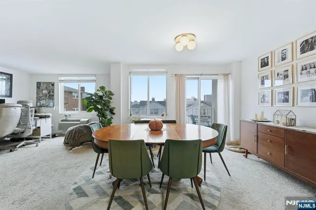 a view of a dining room with furniture and a window