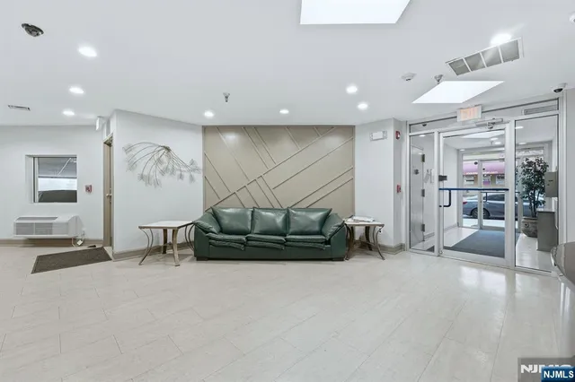 a living room with furniture gym equipment and a ceiling fan