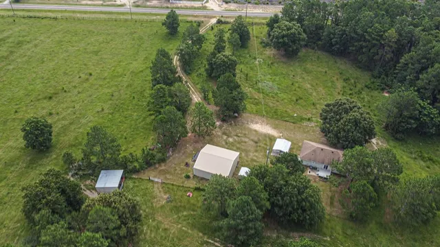 an aerial view of a house with a yard