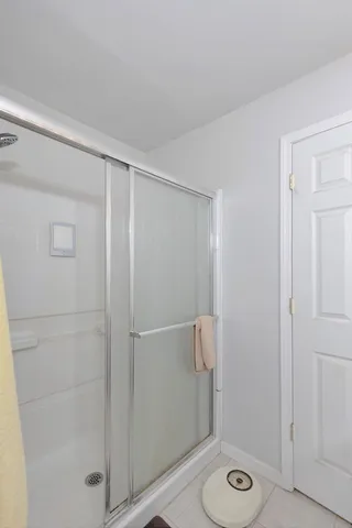 a kitchen with stainless steel appliances a stove top oven a sink a refrigerator white cabinets and wooden floor