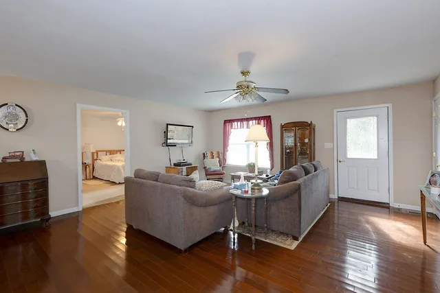 a living room with furniture window and wooden floor