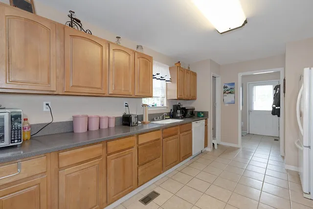 a kitchen with stainless steel appliances granite countertop a sink and cabinets