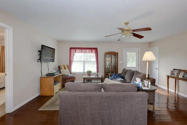a living room with fireplace furniture and a window