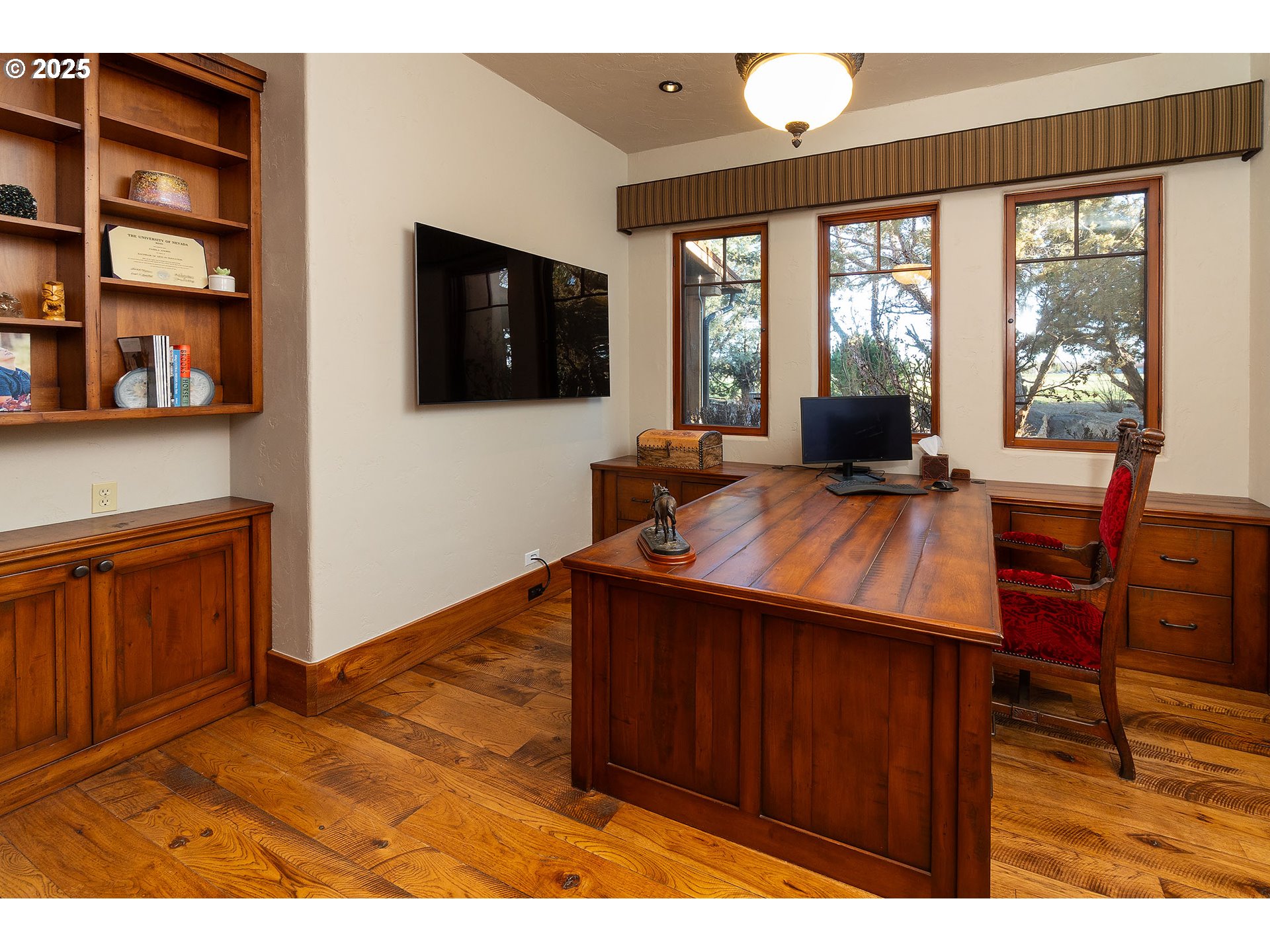 23021 Brushline Court Bend, OR 97701 - Photo 17 of 44 a living room with furniture a flat screen tv and a floor to ceiling window