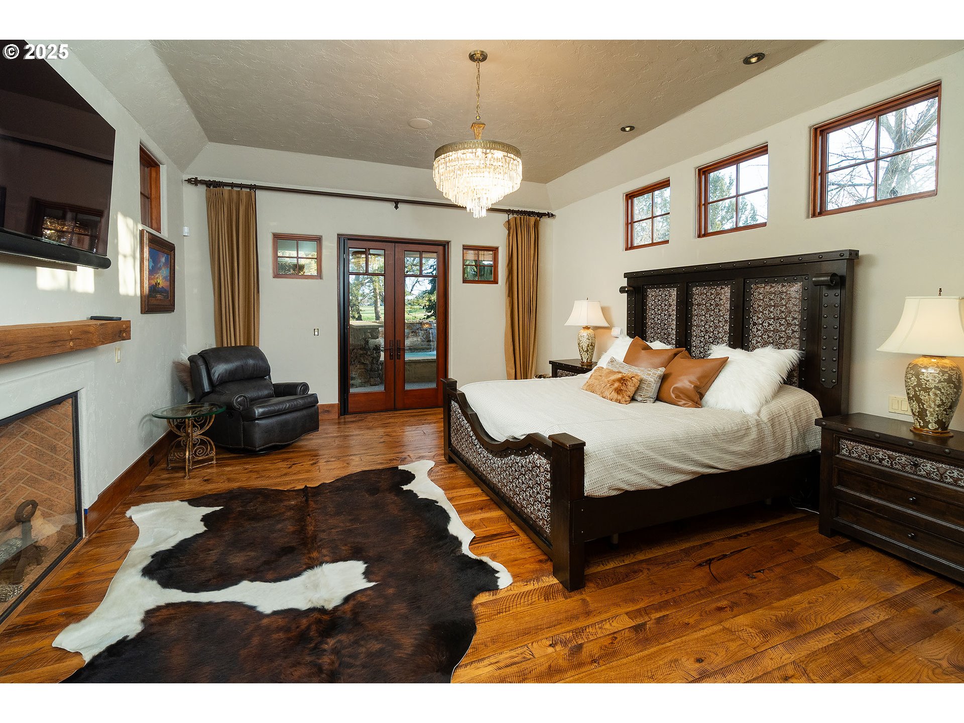 23021 Brushline Court Bend, OR 97701 - Photo 20 of 44 a bedroom with a bed window and a flat screen tv