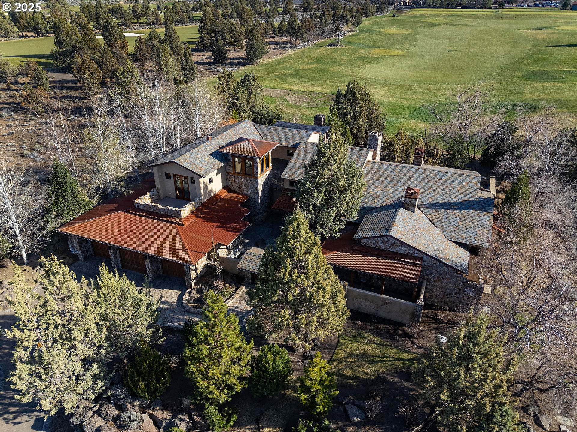 23021 Brushline Court Bend, OR 97701 - Photo 2 of 44 an aerial view of a house with a garden and lake view